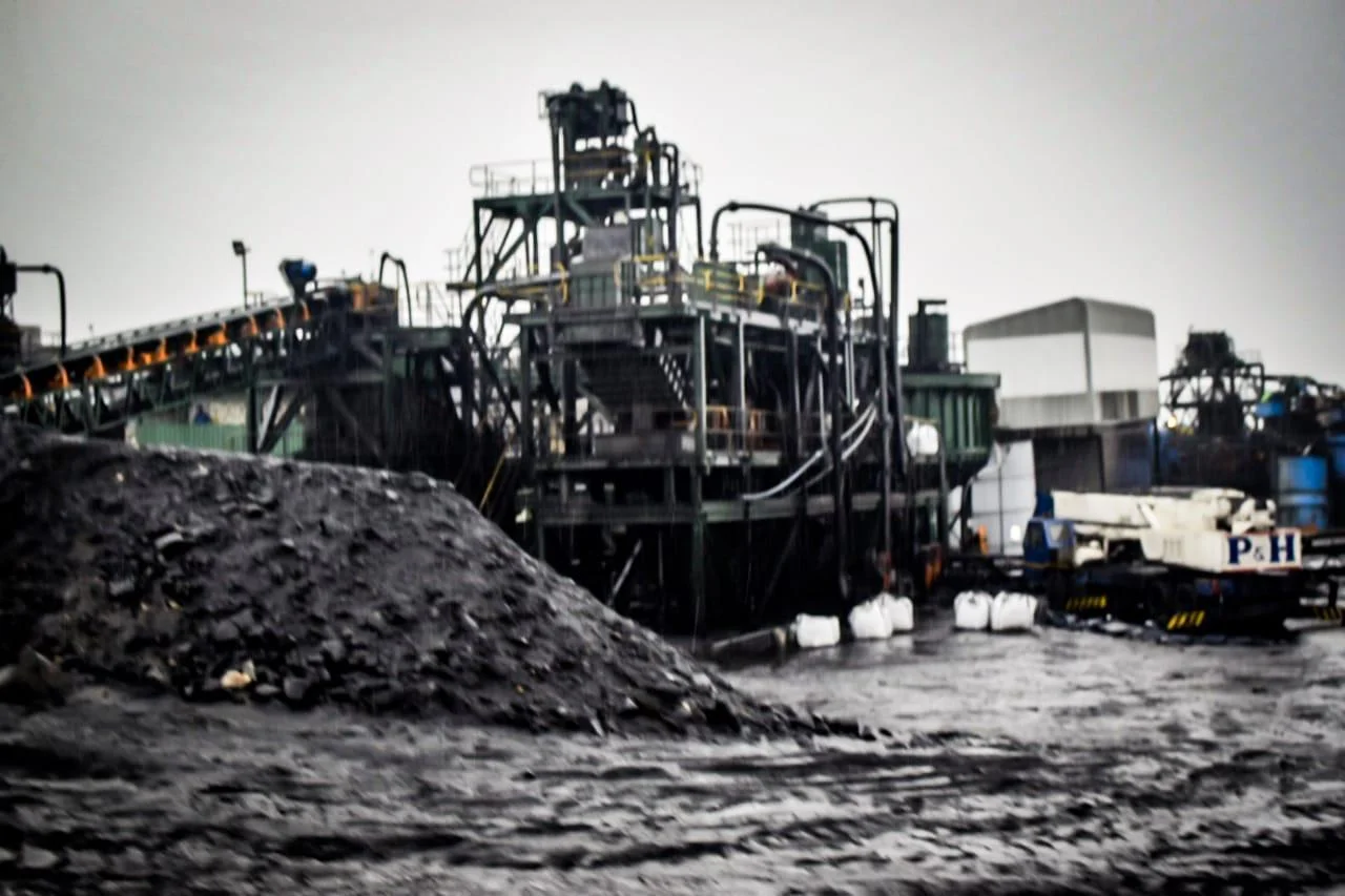 Coal wash plant and stockpile with a mobile crane on site